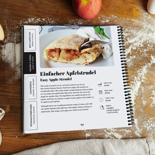 Open More Baking Just Like Oma Journal Edition spiral cookbook showing Apfelstrudel recipe with photo and German-English text.