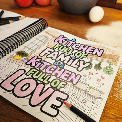 Coloring page from More Baking Just Like Oma Journal Edition, spiral German baking cookbook featuring “A Kitchen Full of Family is a Kitchen Full of Love” design on a wooden table with pencils and flour.