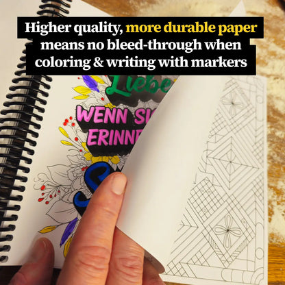 Close-up of More Baking Just Like Oma Journal Edition spiral cookbook showing thick, high-quality paper for coloring and writing without bleed-through.