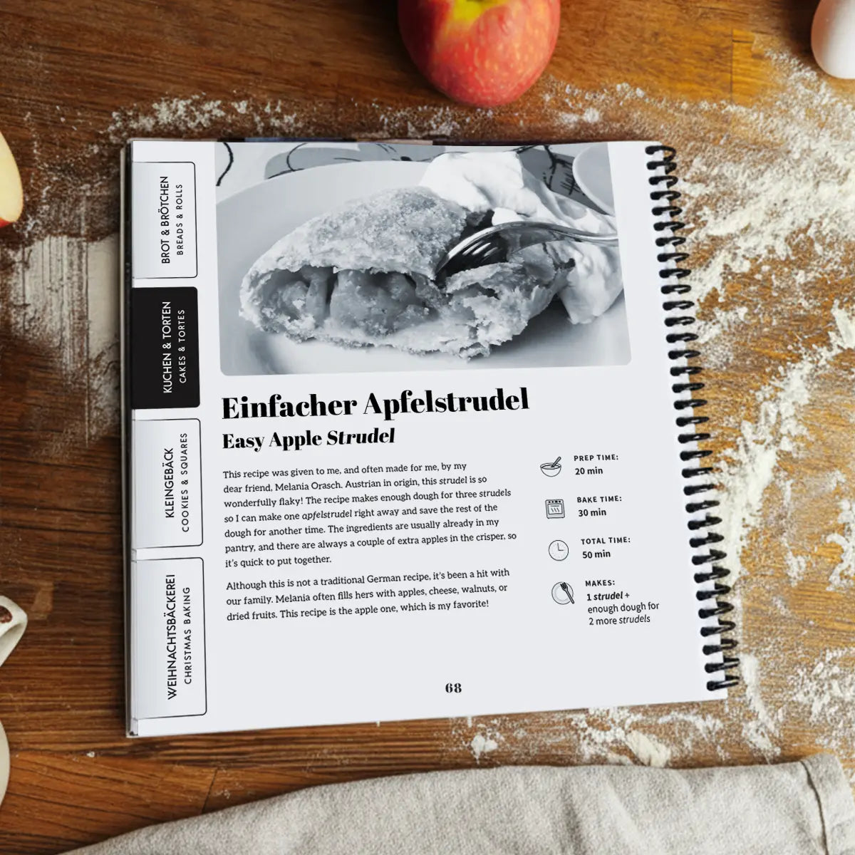 Open More Baking Just Like Oma Journal Edition spiral cookbook showing Easy Apple Strudel recipe with German and English text, traditional German baking cookbook.